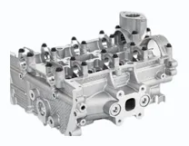 MONTTRON cylinder head: a bare aluminium head seen from the side, with the valve guides, the camshaft bearing saddles and the intake ports machined